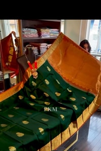 Bottle Green Banarasi Soft Silk Saree with Contrast Orange Border and Checked Orange Pallu  in Surat