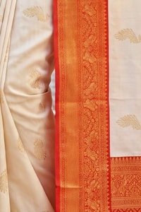 Cream Banarasi Soft Silk Saree with Gold Zari Buttas and Contrast Maroon Zari Border  in Surat