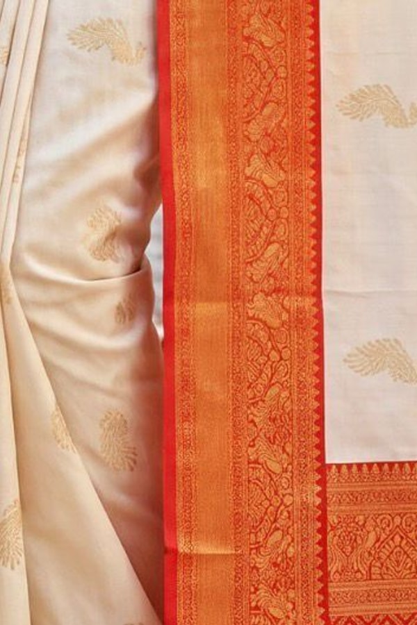 Cream Banarasi Soft Silk Saree with Gold Zari Buttas and Contrast Maroon Zari Border  in Surat