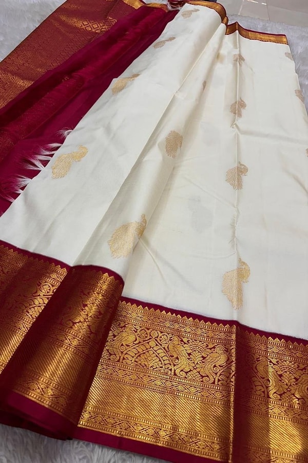 Cream Banarasi Soft Silk Saree with Gold Zari Buttas and Contrast Maroon Zari Border  in Surat