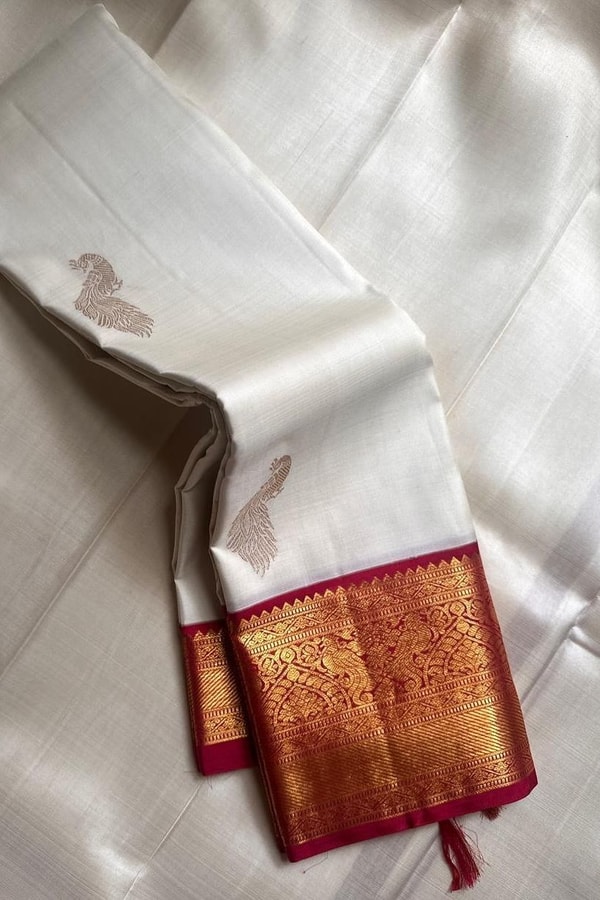 Cream Banarasi Soft Silk Saree with Gold Zari Buttas and Contrast Maroon Zari Border  in Surat