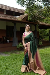 Emerald Green Banarasi Soft Silk Saree with Gold Zari Buttis and Peach Pink Woven Border  in Surat