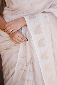 Ivory White Banarasi Soft Silk Saree with Gold Zari Leaf Buttas and Subtle Zari Border  in Surat