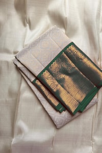 Kanjivaram-Style Cream Banarasi Soft Silk Saree with Wide Gold Zari Border in Green or Red  in Surat