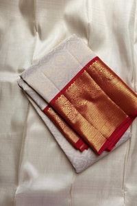 Kanjivaram-Style Cream Banarasi Soft Silk Saree with Wide Gold Zari Border in Green or Red  in Surat