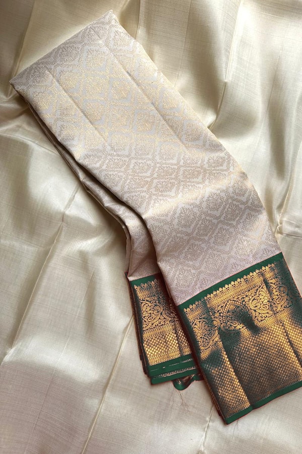 Kanjivaram-Style Cream Banarasi Soft Silk Saree with Wide Gold Zari Border in Green or Red  in Surat