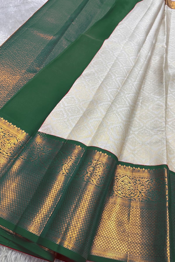 Kanjivaram-Style Cream Banarasi Soft Silk Saree with Wide Gold Zari Border in Green or Red  in Surat