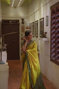 Lemon Yellow Banarasi Soft Silk Saree with Polka Buttis and Contrast Dark Brocade Border  in Surat