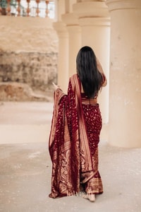 Maroon Banarasi Soft Silk Saree with Dense All-Over Gold Zari Motifs and Zari Border  in Surat