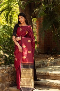 Maroon Banarasi Soft Silk Saree with Gold Zari Buttas and Black Contrast Border  in Surat