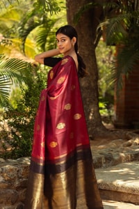 Maroon Banarasi Soft Silk Saree with Gold Zari Buttas and Black Contrast Border  in Surat