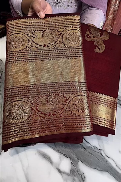 Maroon Banarasi Soft Silk Saree with Gold Zari Buttas and Wide Brocade Border in Surat
