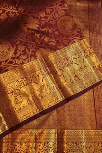 Maroon Bridal Banarasi Soft Silk Saree with All-Over Gold Zari Brocade and Heavy Border  in Surat