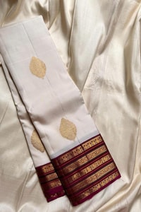 Off-White Banarasi Soft Silk Saree with Gold Buttas and Contrast Magenta Striped Border  in Surat