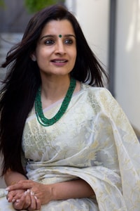 Off-White Saree with Pastel Green Woven Floral Motifs and Soft Silver Zari Accents  in Surat