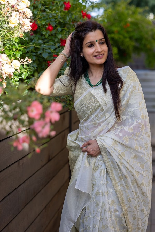 Off-White Saree with Pastel Green Woven Floral Motifs and Soft Silver Zari Accents  in Surat
