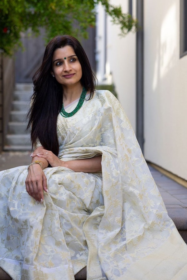 Off-White Saree with Pastel Green Woven Floral Motifs and Soft Silver Zari Accents  in Surat