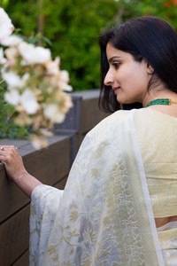 Off-White Saree with Pastel Green Woven Floral Motifs and Soft Silver Zari Accents  in Surat