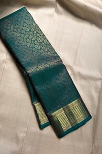 Peacock Teal Banarasi Soft Silk Saree with All-Over Zari Motifs and Gold Temple Border  in Surat