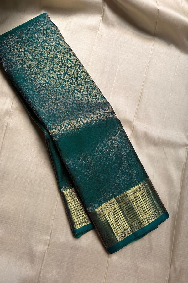Peacock Teal Banarasi Soft Silk Saree with All-Over Zari Motifs and Gold Temple Border  in Surat
