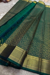 Peacock Teal Banarasi Soft Silk Saree with All-Over Zari Motifs and Gold Temple Border  in Surat
