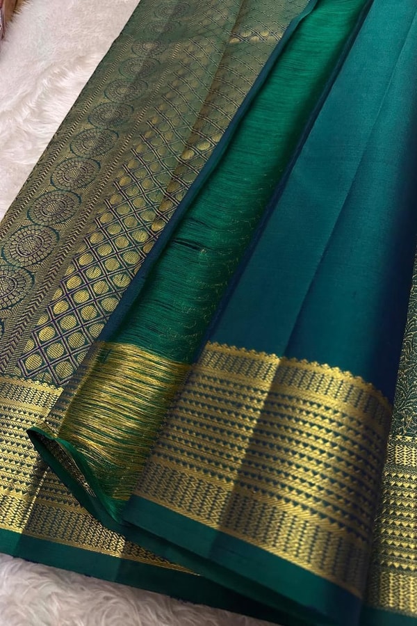 Peacock Teal Banarasi Soft Silk Saree with All-Over Zari Motifs and Gold Temple Border  in Surat