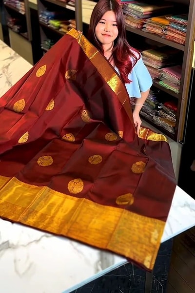 Rust Maroon Banarasi Soft Silk Saree with Gold Coin Buttis and Mustard Zari Border in Surat