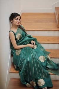 Teal Green Saree with Gold Zari Stripes, Large Floral Motifs and Woven Gold Pallu  in Surat