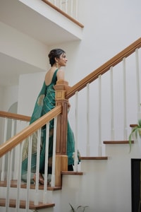 Teal Green Saree with Gold Zari Stripes, Large Floral Motifs and Woven Gold Pallu  in Surat